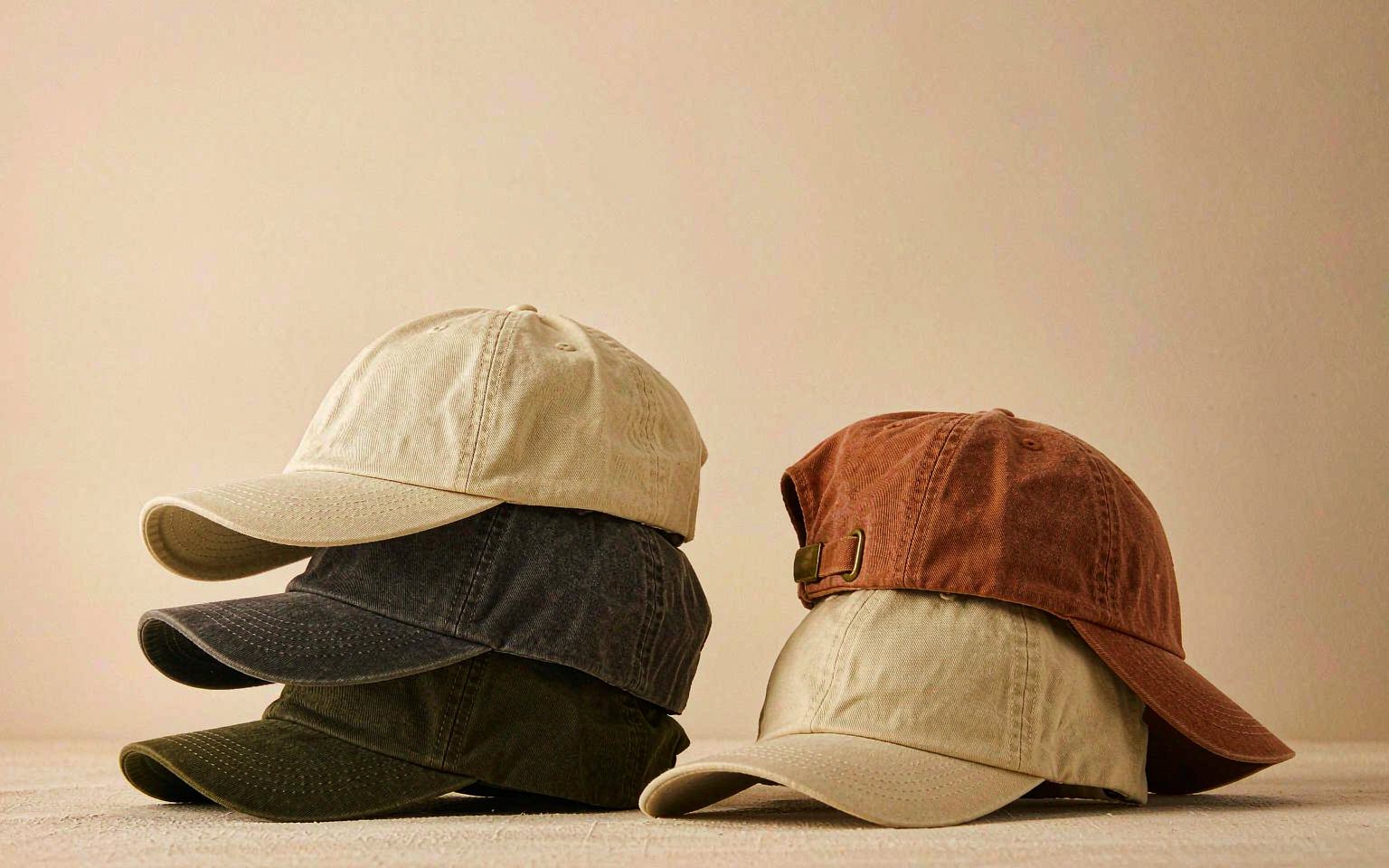 Blank six-panel caps in cream, charcoal, olive and rust
